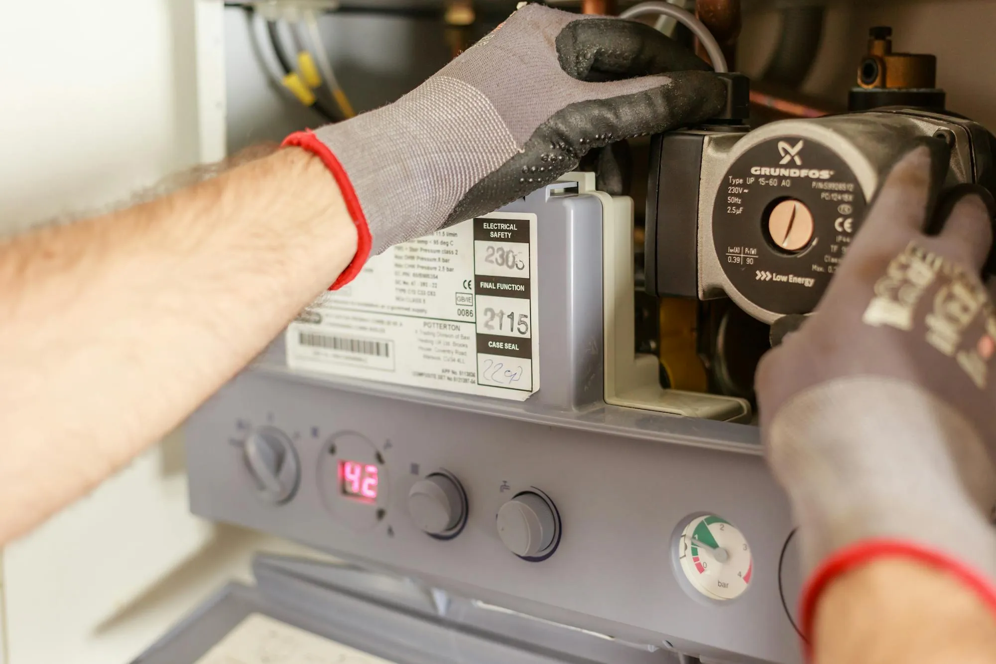 Plumber servicing a Potterton combi boiler in an Exeter home